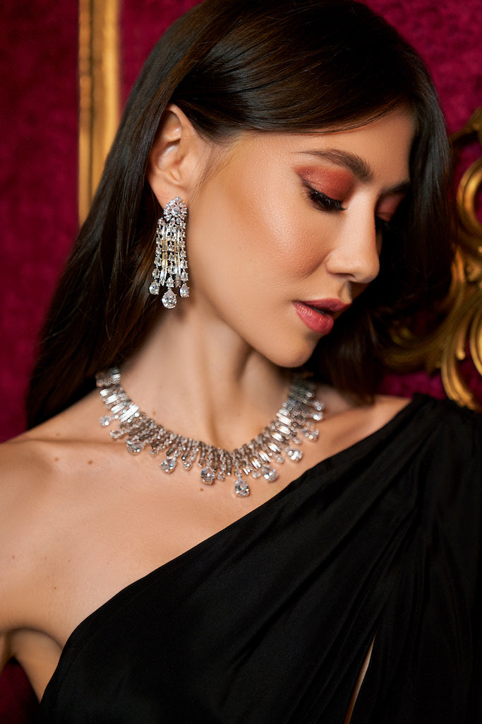 




























Drape yourself in luxury with our Venya statement necklace set. This necklace and earrings set was made with everyday glamour in mind. WJaipur RoseJaipur RoseNecklace and Earring SetVenya White Gold Statement Necklace & Earring Set