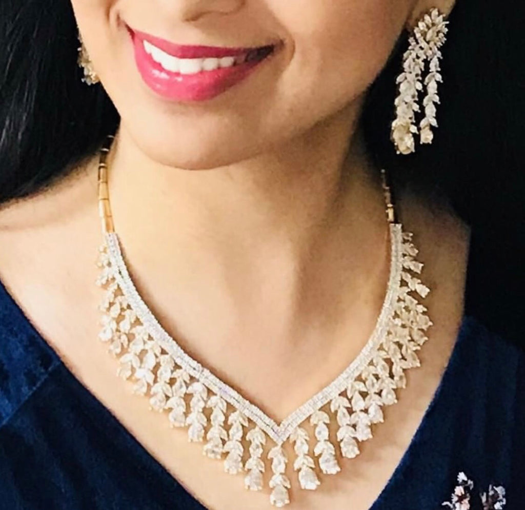 
Dare to be dramatic with our Amala Chandelier Necklace and Earring set, the ultimate statement piece for any luxury jewelry collection. Its exquisite design and flaJaipur RoseJaipur RoseNecklace and Earring SetAmala Chandelier Statement Necklace Set Designer Gold Plated Fashion J