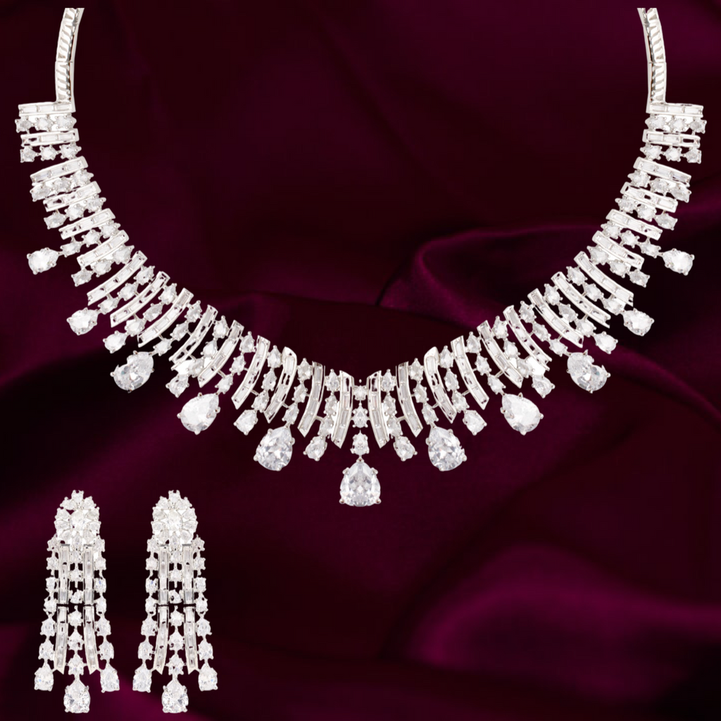 




























Drape yourself in luxury with our Venya statement necklace set. This necklace and earrings set was made with everyday glamour in mind. WJaipur RoseJaipur RoseNecklace and Earring SetVenya White Gold Statement Necklace & Earring Set